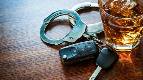 DUI symbolized with handcuffs and alcohol